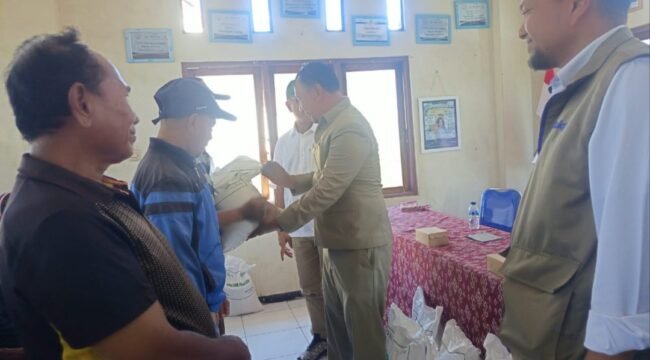 Anggota DPRD NTT, Marselinus Anggur Ngganggus saat menyerahkan bantuan beras kepada warga Bakunase 